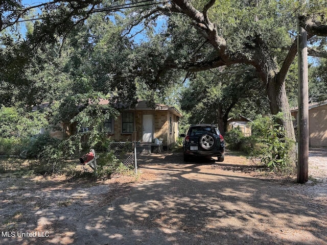 view of property hidden behind natural elements