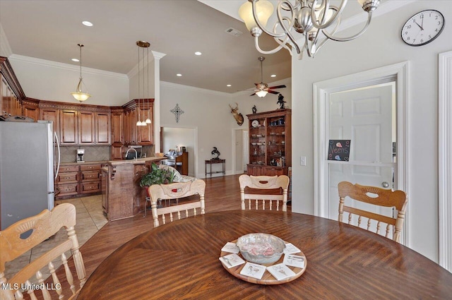 dining area with ornamental molding, recessed lighting, visible vents, and ceiling fan with notable chandelier