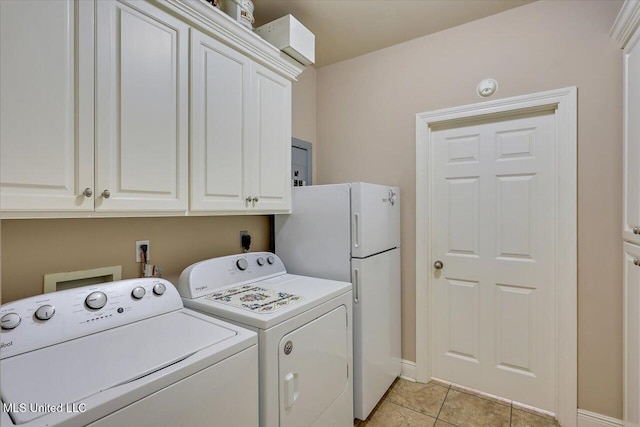 laundry room featuring light tile patterned floors, cabinet space, and separate washer and dryer