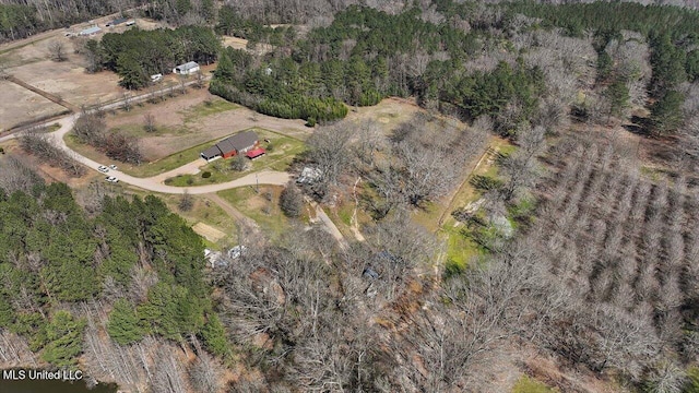 drone / aerial view featuring a wooded view