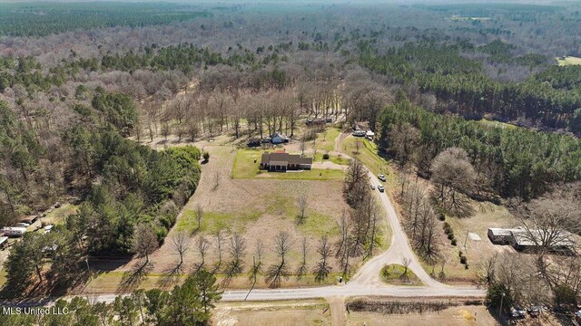 drone / aerial view featuring a forest view