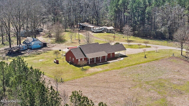 birds eye view of property featuring a forest view and a rural view