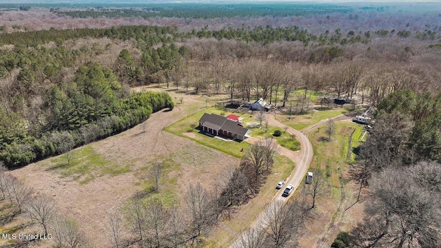 bird's eye view featuring a wooded view