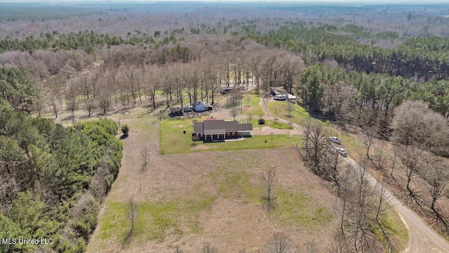 drone / aerial view featuring a rural view and a view of trees