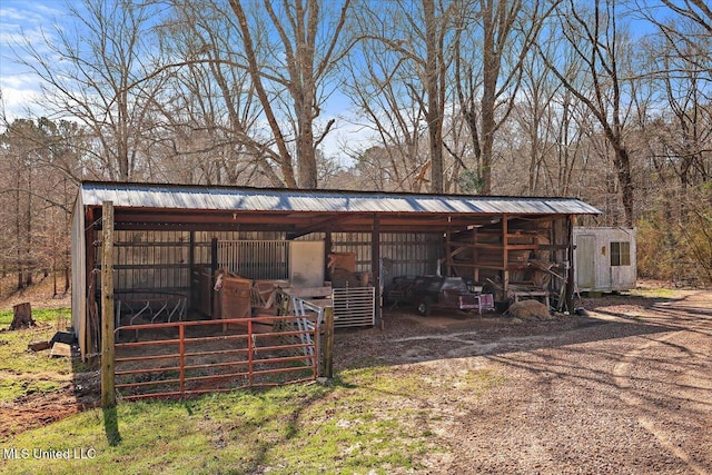 view of outbuilding with an outbuilding and dirt driveway