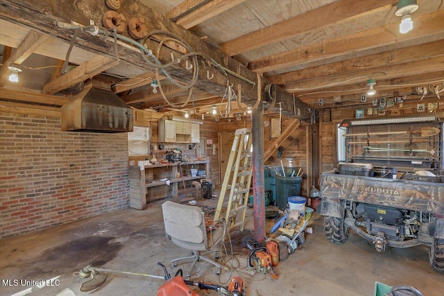 basement featuring brick wall and a workshop area