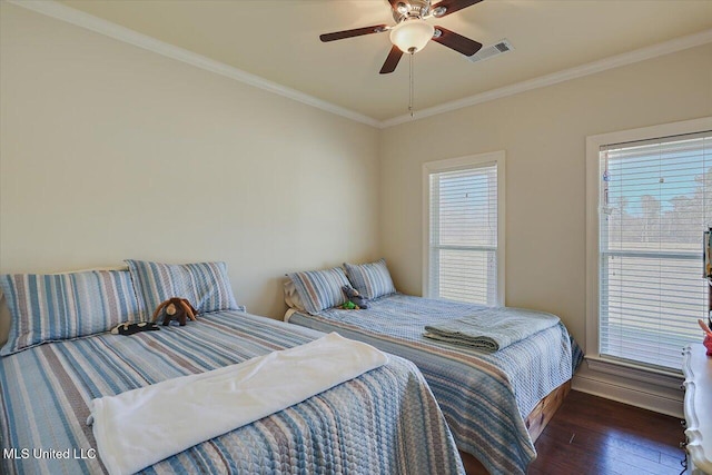 bedroom with ceiling fan, ornamental molding, wood finished floors, and visible vents