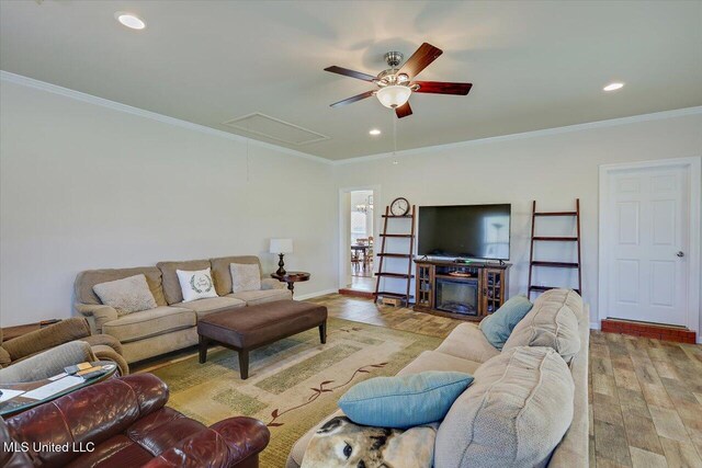 living room featuring recessed lighting, attic access, ornamental molding, wood finished floors, and baseboards