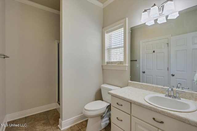 bathroom with baseboards, toilet, tile patterned floors, crown molding, and vanity