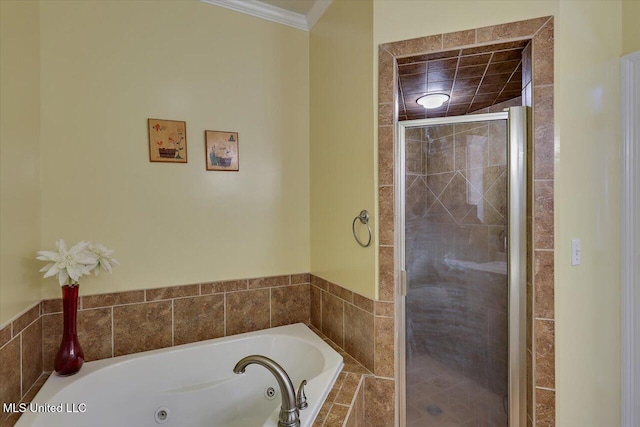 bathroom with ornamental molding, a shower stall, and a tub with jets