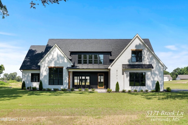 5171 Brook Ln, Hernando, MS 38632 - modern farmhouse featuring a front lawn, roof with shingles, and a standing seam roof