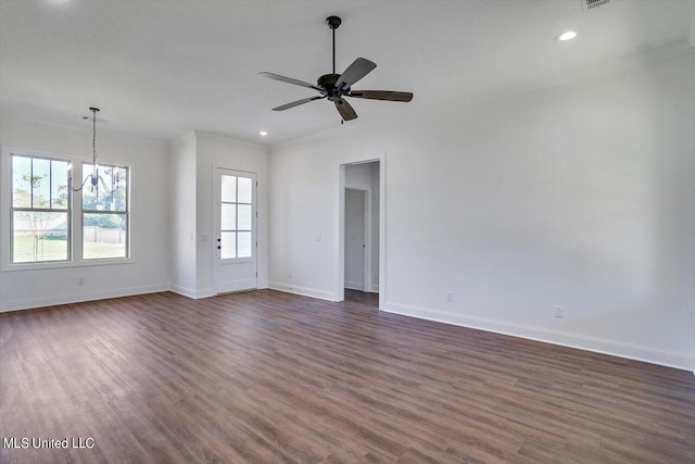 spare room featuring ceiling fan with notable chandelier, dark hardwood / wood-style floors, and ornamental molding