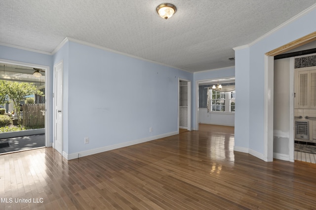 unfurnished living room with a textured ceiling, crown molding, and dark wood-type flooring