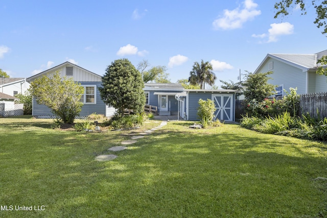 rear view of property with a yard