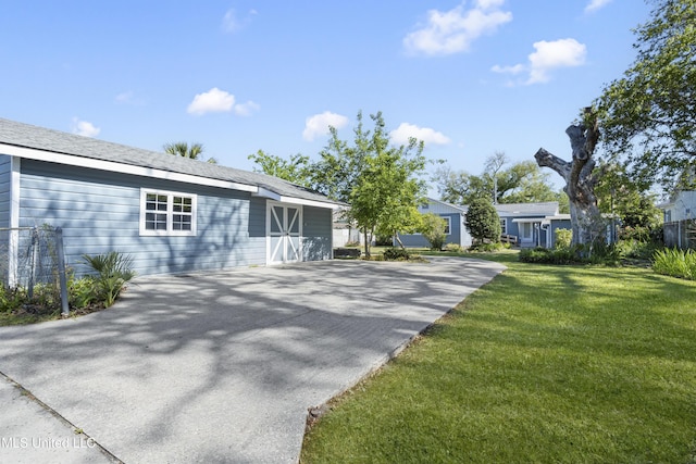 back of property featuring a yard