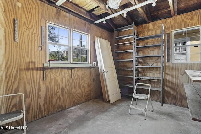 interior space with wood walls and concrete flooring