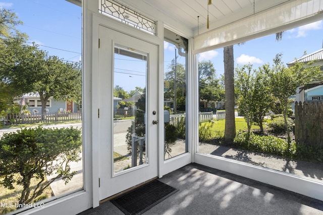 doorway to outside featuring dark carpet