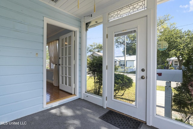 entryway with dark colored carpet