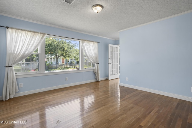 unfurnished room with a textured ceiling, hardwood / wood-style floors, and ornamental molding