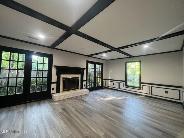 767 Sherwood Dr, Jackson, MS 39216 - unfurnished living room featuring french doors, coffered ceiling, wood finished floors, a wainscoted wall, and a fireplace