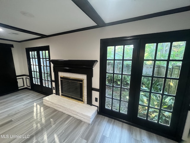 767 Sherwood Dr, Jackson, MS 39216 - unfurnished living room featuring a fireplace, wood finished floors, and plenty of natural light