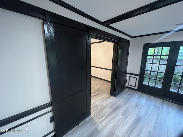 767 Sherwood Dr, Jackson, MS 39216 - doorway featuring a barn door, light wood-style floors, and beamed ceiling
