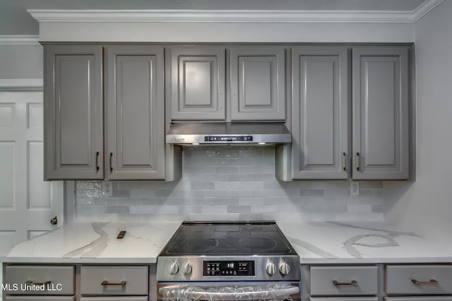 767 Sherwood Dr, Jackson, MS 39216 - kitchen with gray cabinets, electric range, under cabinet range hood, backsplash, and crown molding