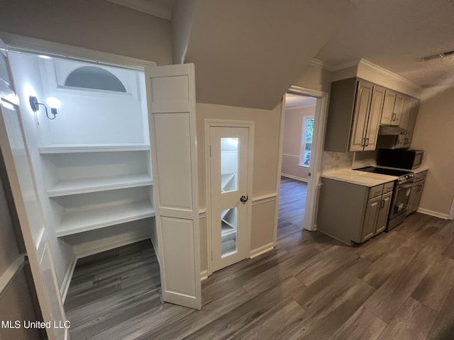767 Sherwood Dr, Jackson, MS 39216 - kitchen featuring dark wood-style floors, light countertops, stainless steel electric range oven, crown molding, and baseboards