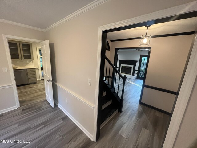767 Sherwood Dr, Jackson, MS 39216 - corridor with dark wood-style floors, ornamental molding, stairway, and baseboards