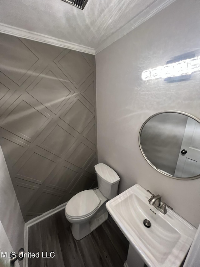 767 Sherwood Dr, Jackson, MS 39216 - half bathroom featuring a sink, wood finished floors, and toilet