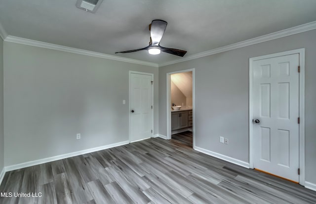 767 Sherwood Dr, Jackson, MS 39216 - unfurnished bedroom featuring wood finished floors, baseboards, crown molding, connected bathroom, and ceiling fan