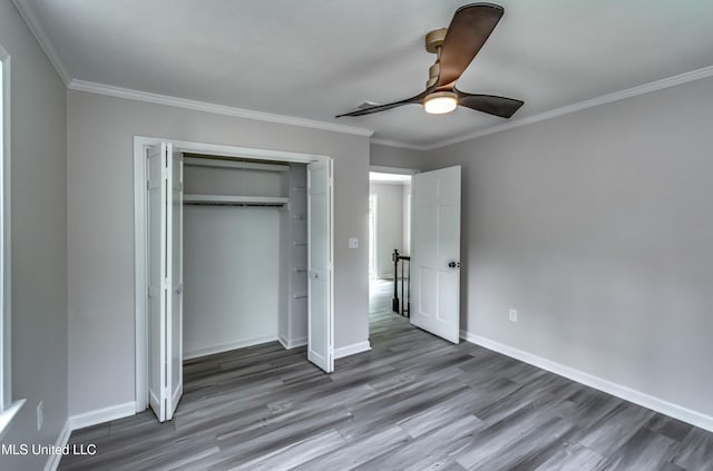 767 Sherwood Dr, Jackson, MS 39216 - unfurnished bedroom with wood finished floors, a closet, crown molding, baseboards, and ceiling fan