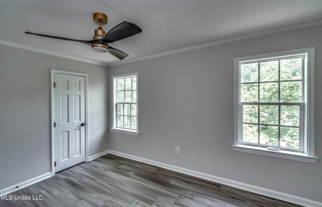 767 Sherwood Dr, Jackson, MS 39216 - spare room featuring crown molding, baseboards, wood finished floors, and a ceiling fan