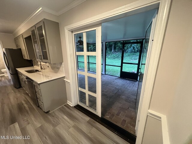 767 Sherwood Dr, Jackson, MS 39216 - doorway featuring crown molding, a sink, and dark wood-style floors