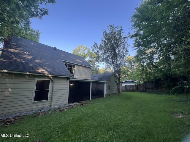 767 Sherwood Dr, Jackson, MS 39216 - rear view of house with roof with shingles and a sunroom