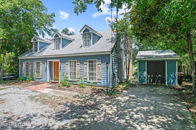 cape cod-style house with a shed