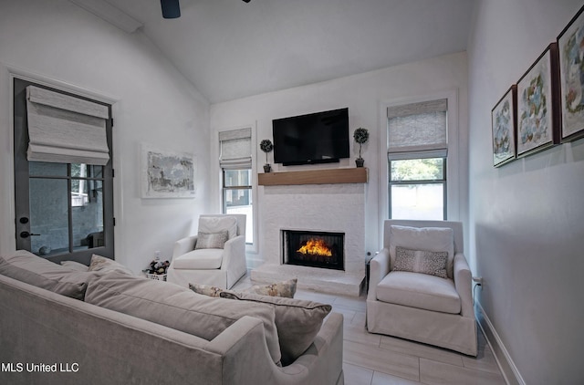 220 S Woodcreek Rd, Madison, MS 39110 - living room with healthy amount of natural light, a stone fireplace, lofted ceiling, and ceiling fan