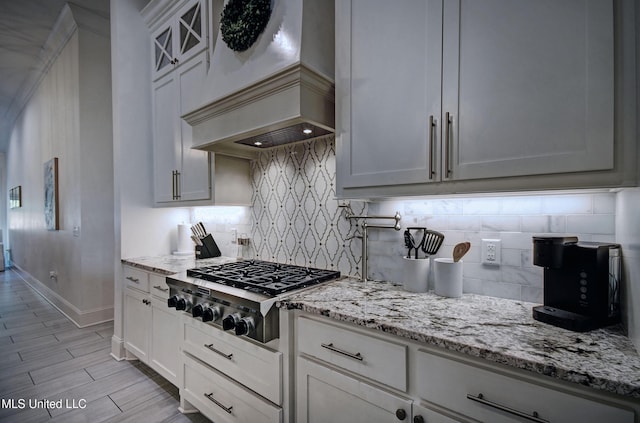 220 S Woodcreek Rd, Madison, MS 39110 - kitchen featuring premium range hood, stainless steel gas cooktop, light stone countertops, and tasteful backsplash