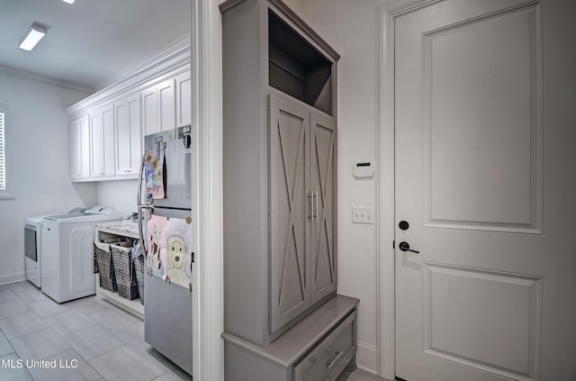 220 S Woodcreek Rd, Madison, MS 39110 - laundry room with washing machine and dryer, crown molding, light tile patterned flooring, and cabinet space