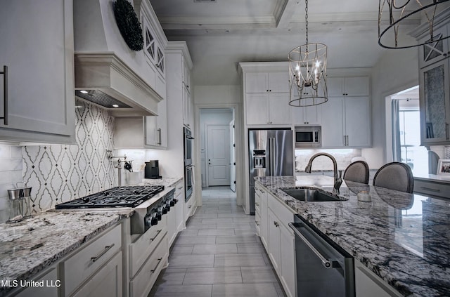 220 S Woodcreek Rd, Madison, MS 39110 - kitchen featuring stainless steel appliances, a chandelier, white cabinets, backsplash, and premium range hood