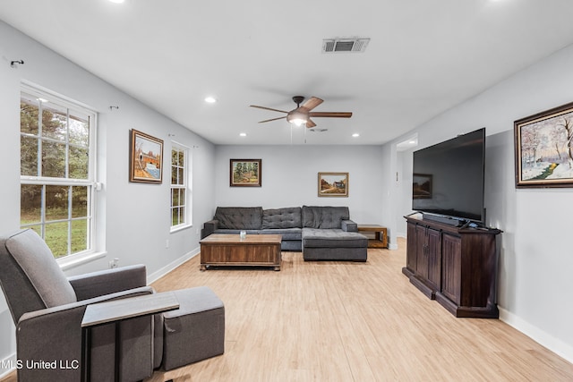 living room featuring ceiling fan and light hardwood / wood-style floors