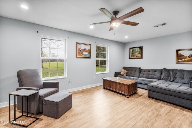 living room featuring ceiling fan and light wood-type flooring