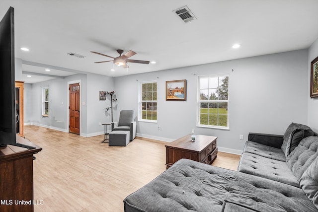 living room featuring ceiling fan and light wood-type flooring