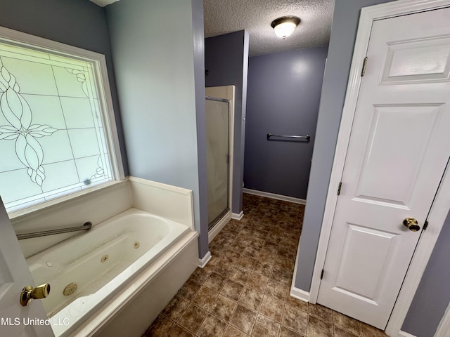 221 N Third Ave, Cleveland, MS 38732 - bathroom featuring a whirlpool tub, a stall shower, baseboards, and a textured ceiling