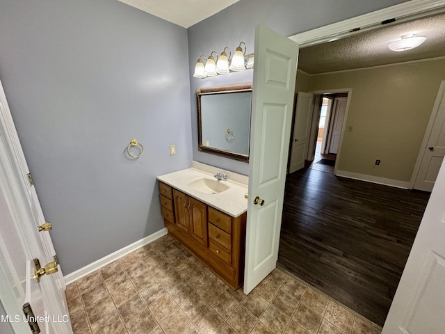 221 N Third Ave, Cleveland, MS 38732 - bathroom with vanity, baseboards, and a textured ceiling