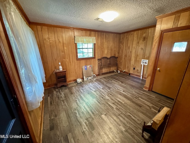 221 N Third Ave, Cleveland, MS 38732 - unfurnished room featuring crown molding, a textured ceiling, wood finished floors, baseboards, and wood walls