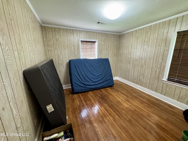 221 N Third Ave, Cleveland, MS 38732 - unfurnished bedroom featuring wood finished floors, wooden walls, baseboards, and ornamental molding