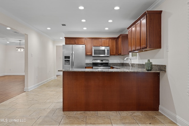 kitchen with dark stone counters, sink, crown molding, kitchen peninsula, and stainless steel appliances