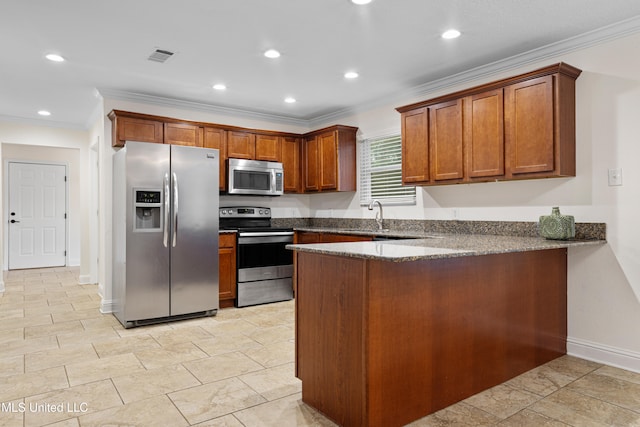 kitchen with kitchen peninsula, ornamental molding, appliances with stainless steel finishes, and dark stone counters