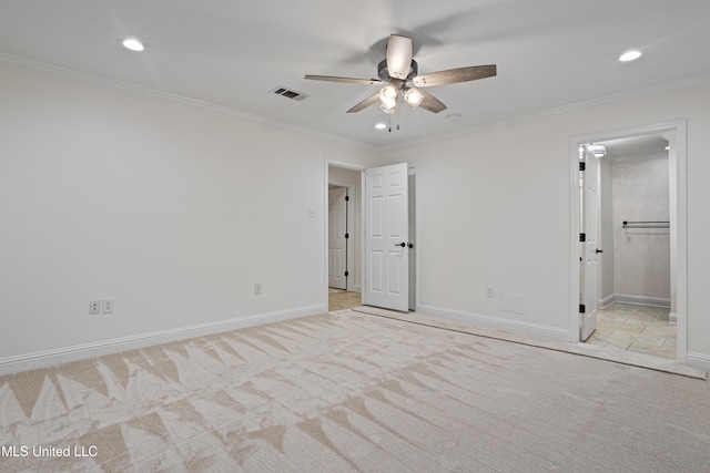 unfurnished bedroom with connected bathroom, crown molding, ceiling fan, and light carpet